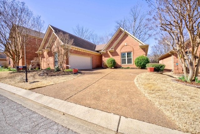 view of front of home with concrete driveway, an attached garage, and brick siding