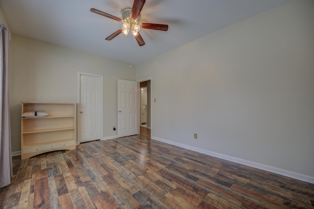 unfurnished bedroom with a ceiling fan, baseboards, and dark wood-style flooring