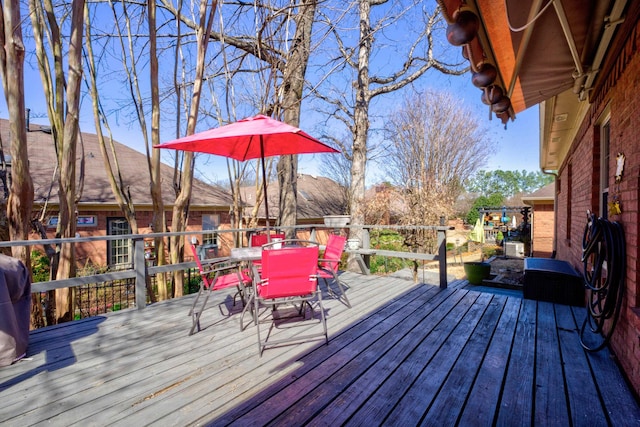 wooden deck featuring outdoor dining space