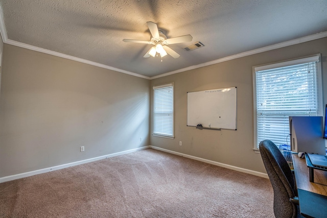 unfurnished office featuring visible vents, ornamental molding, carpet flooring, baseboards, and ceiling fan