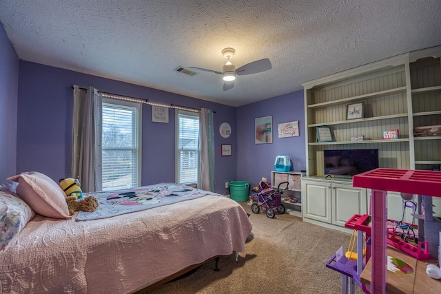 bedroom featuring visible vents, a textured ceiling, a ceiling fan, and carpet floors