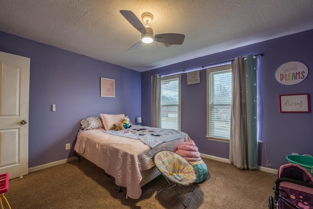 bedroom with baseboards, carpet, ceiling fan, and a textured ceiling