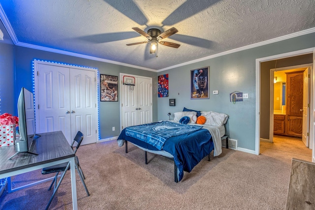 carpeted bedroom with baseboards, two closets, ornamental molding, and a textured ceiling