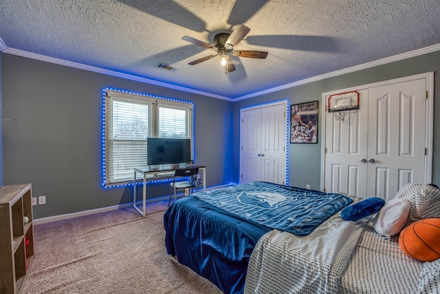 bedroom featuring carpet, baseboards, visible vents, ornamental molding, and two closets