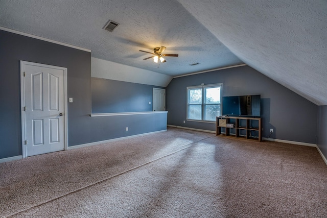 additional living space with vaulted ceiling, visible vents, baseboards, and carpet floors