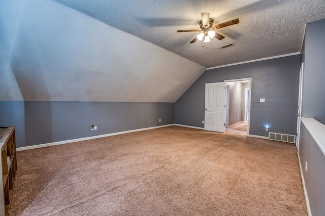 bonus room with vaulted ceiling, visible vents, carpet floors, and a textured ceiling