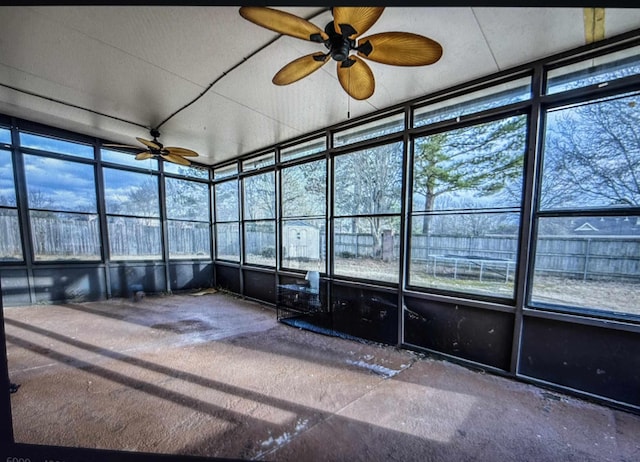 unfurnished sunroom with a healthy amount of sunlight and a ceiling fan