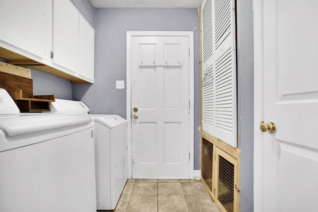 laundry room featuring cabinet space, independent washer and dryer, and light tile patterned flooring