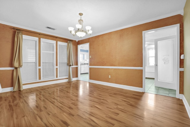 unfurnished room with visible vents, crown molding, baseboards, a chandelier, and wood finished floors