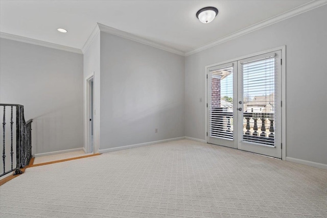 spare room with light colored carpet, french doors, crown molding, and baseboards