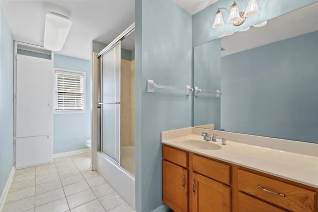 bathroom with tile patterned floors, toilet, vanity, and baseboards