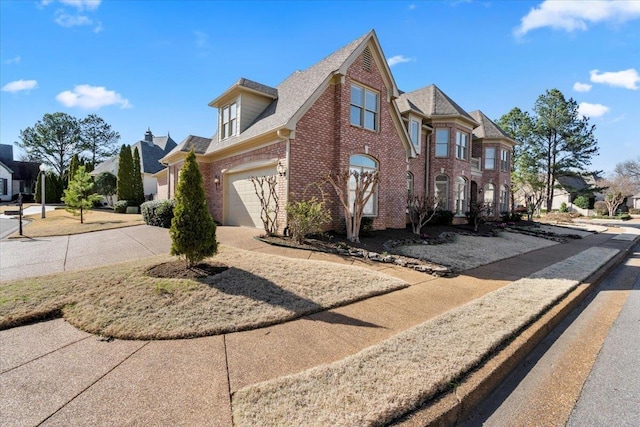 view of side of home featuring driveway, brick siding, and a residential view