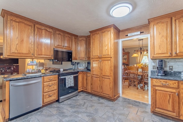 kitchen featuring dark countertops, stainless steel appliances, brown cabinetry, and tasteful backsplash