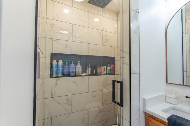 full bathroom with a stall shower and vanity