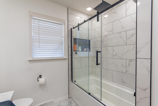 full bath with toilet, baseboards, visible vents, and a combined bath / shower with rainfall shower