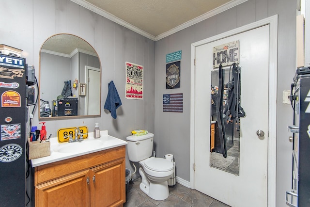 bathroom featuring vanity, toilet, and ornamental molding