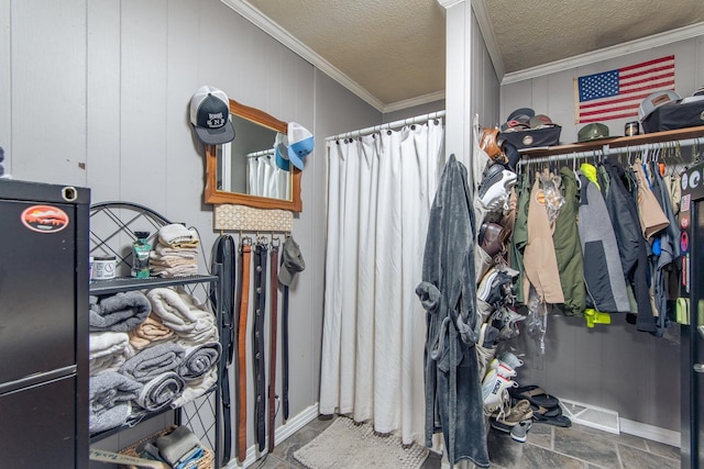 spacious closet with visible vents and stone finish floor