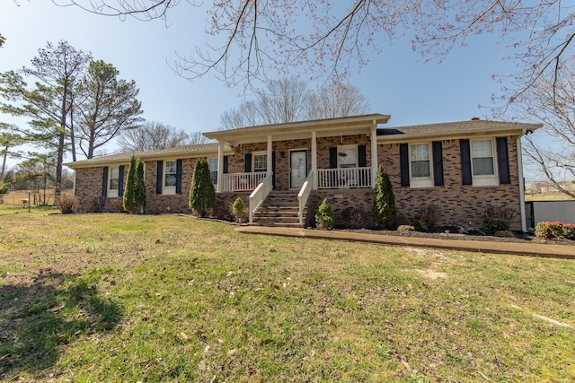 ranch-style home with a front yard, brick siding, and covered porch