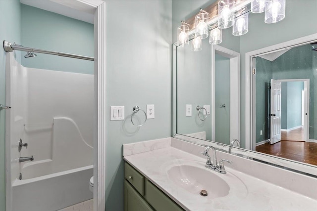 full bathroom with vanity, toilet, and washtub / shower combination