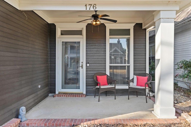 doorway to property with covered porch and a ceiling fan