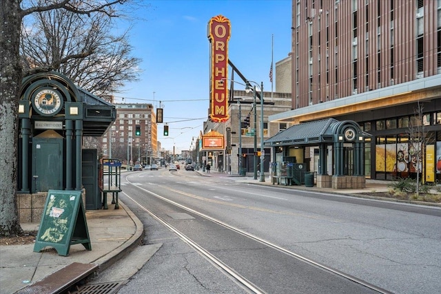 view of road with curbs, sidewalks, and street lighting