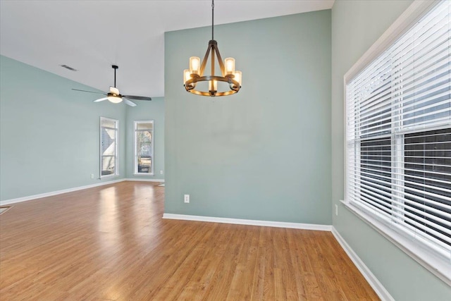 empty room featuring visible vents, baseboards, and wood finished floors