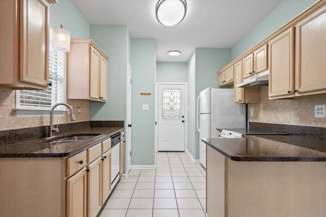 kitchen with under cabinet range hood, light brown cabinetry, light tile patterned flooring, white appliances, and a sink