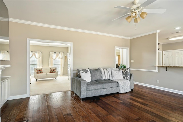 living room with ceiling fan, baseboards, ornamental molding, and hardwood / wood-style flooring