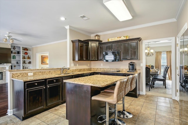 kitchen featuring visible vents, ornamental molding, black appliances, and a sink