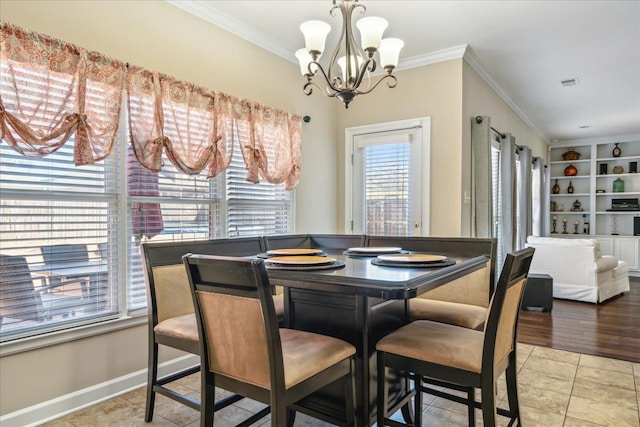 dining room with visible vents, baseboards, an inviting chandelier, and ornamental molding