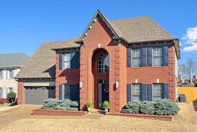 view of front of house with brick siding, driveway, and roof with shingles