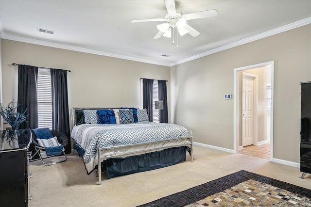 bedroom featuring visible vents, baseboards, light colored carpet, and crown molding