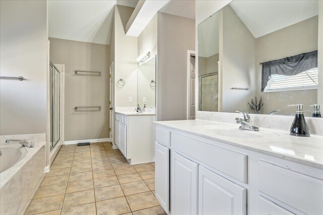 bathroom featuring two vanities, a stall shower, a sink, tile patterned flooring, and a garden tub