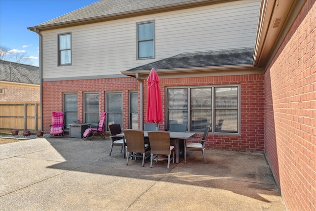 view of patio with outdoor dining area and fence