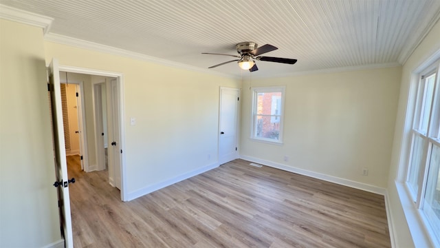 spare room featuring ceiling fan, baseboards, light wood-type flooring, and ornamental molding