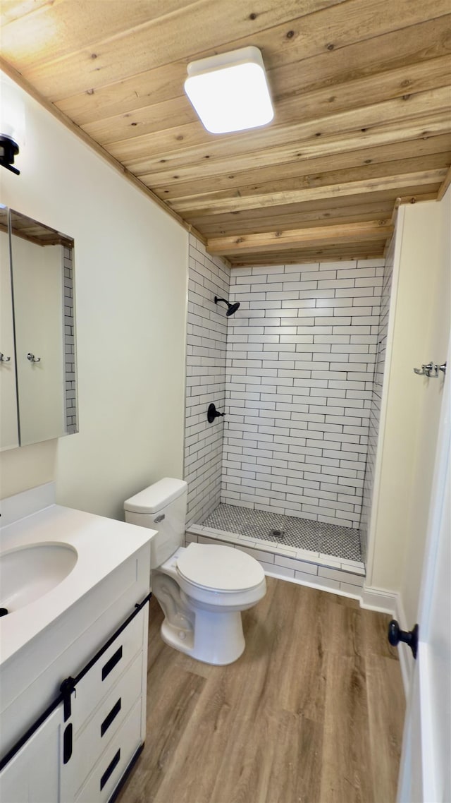 full bathroom featuring a shower stall, wood ceiling, and wood finished floors