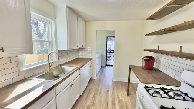 kitchen with open shelves, white appliances, white cabinetry, and a sink