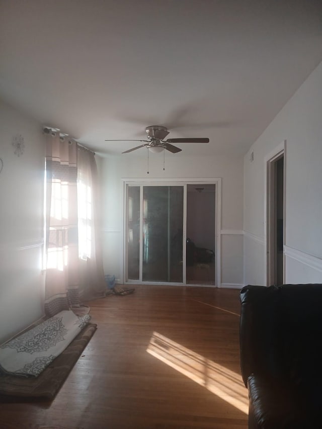 interior space with ceiling fan and wood finished floors