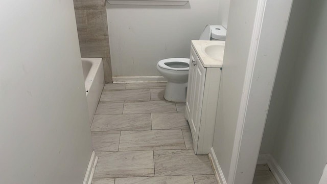 full bath with toilet, marble finish floor, baseboards, a bathtub, and vanity