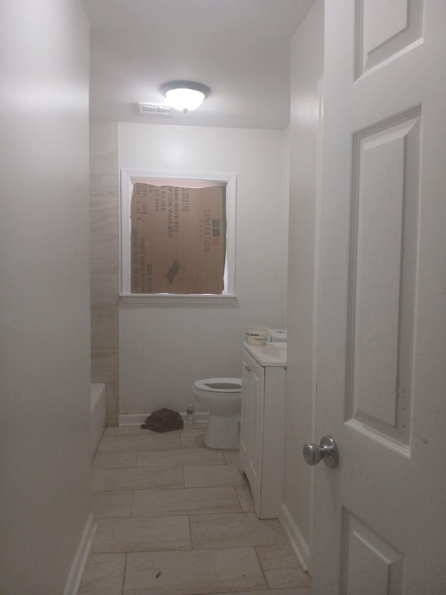 bathroom featuring vanity and toilet