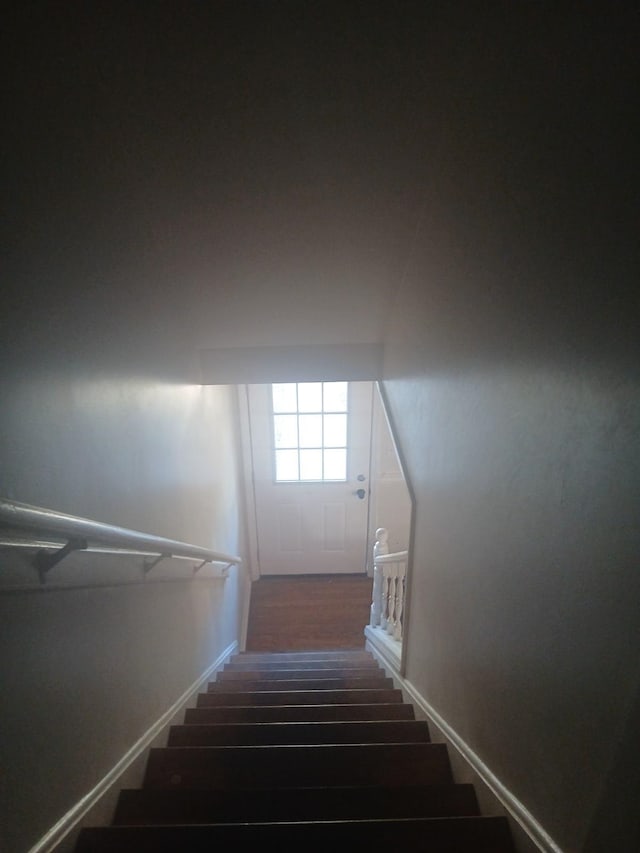 stairway featuring wood finished floors