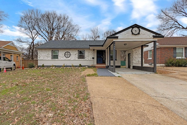 view of front of house featuring driveway, stone siding, roof with shingles, an attached carport, and brick siding