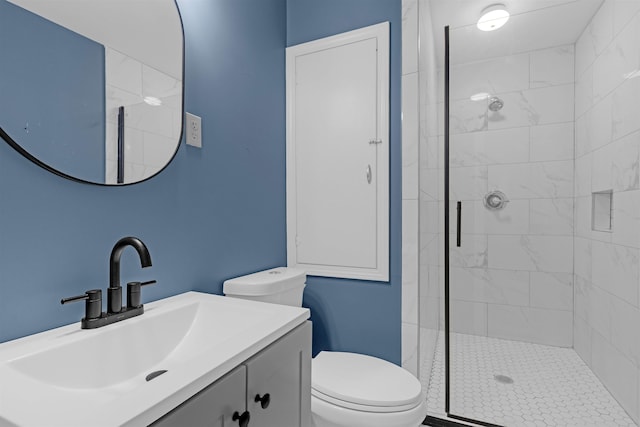 full bath featuring vanity, a shower stall, and toilet