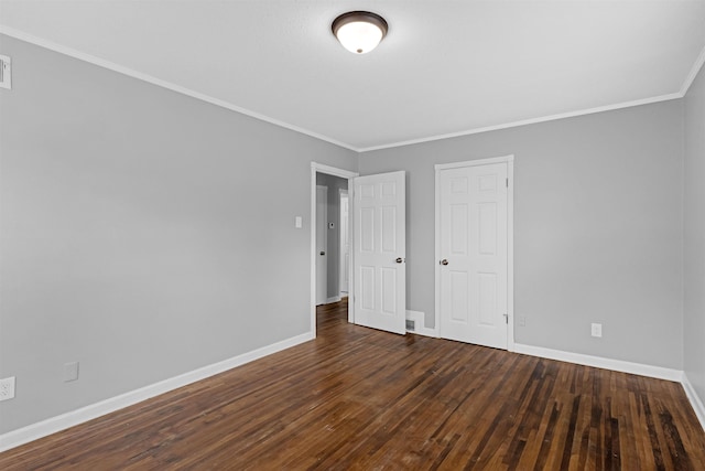 unfurnished bedroom featuring baseboards, wood-type flooring, and crown molding