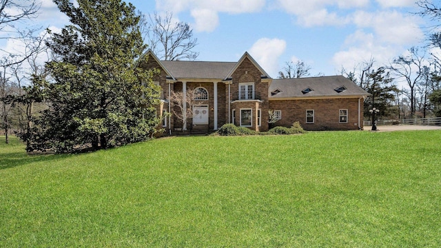 view of front of home featuring brick siding and a front lawn