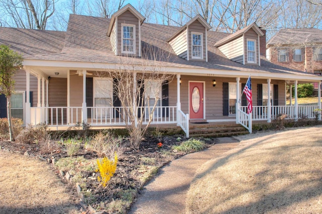 view of front of property with covered porch and roof with shingles