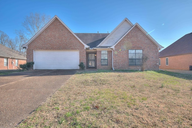 view of front of house with brick siding, an attached garage, driveway, and a front lawn