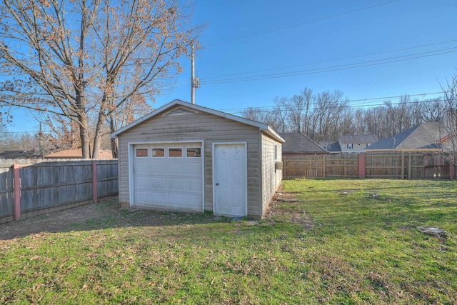 detached garage with driveway and fence