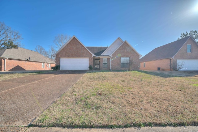 view of front facade featuring brick siding, driveway, a front lawn, and a garage