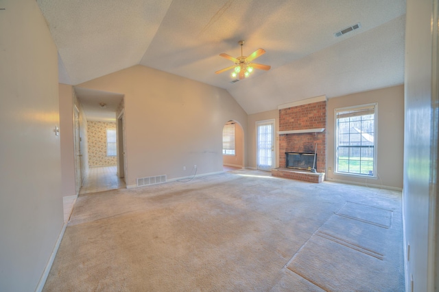 unfurnished living room with visible vents, carpet flooring, and a brick fireplace